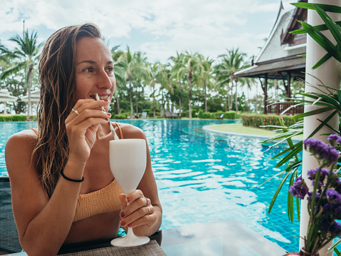 Woman having food for at the pool bar
