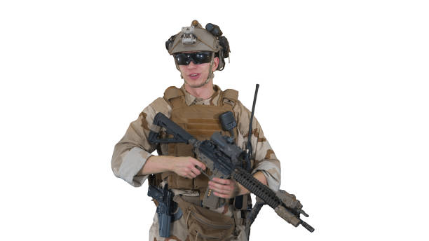 istock Smiling soldier with assault rifle talking on white background 1277979368