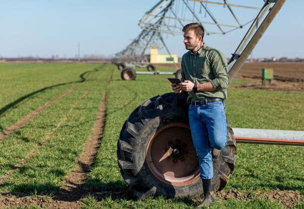 istock Young farmer standing in wheat field and setup irrigation system on tablet. 1277982935