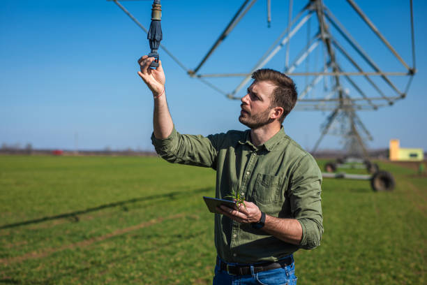 istock Young farmer standing in wheat field and setup irrigation system on tablet. 1277982944