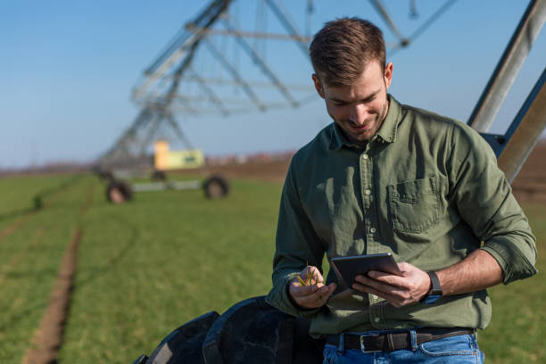 istock Young farmer standing in wheat field and setup irrigation system on tablet. 1277983186