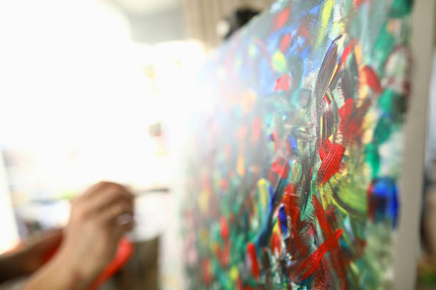 istock Man paints large bright abstract painting picture 1277984280