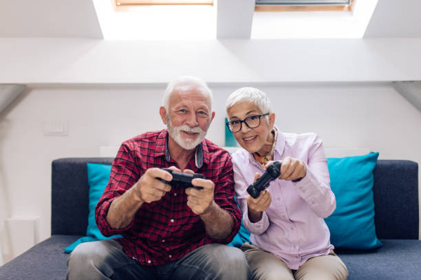 istock Happy senior couple playing video games 1277984356