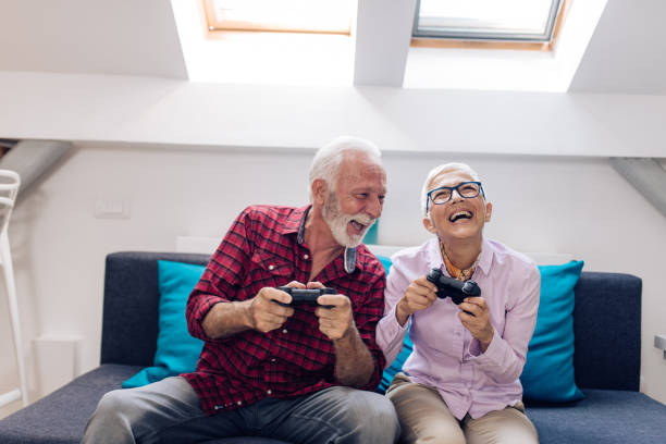 istock Senior couple playing video games and having fun 1277984365