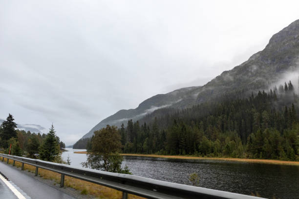 istock Highway road in a misty mountain lake in Norway 1277984496