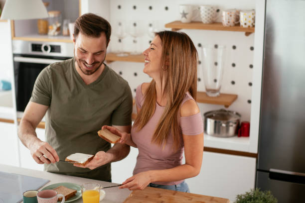 istock Young couple making breakfast at home. 1277985454