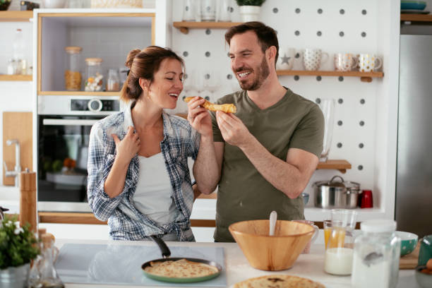istock Young couple making pancakes at home 1277986271