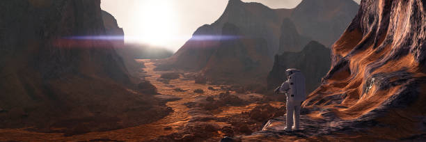 istock astronaut on planet Mars watching the rising Sun 1277986366