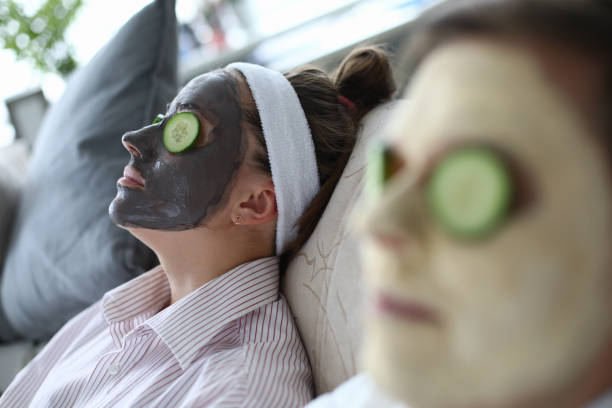 istock People are lying on couch with cosmetic mask faces 1277986437