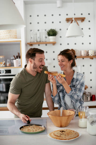 istock Young couple making pancakes at home 1277986494