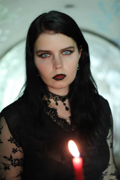 istock Spooky woman walking through tunnel by candlelight 1277987268