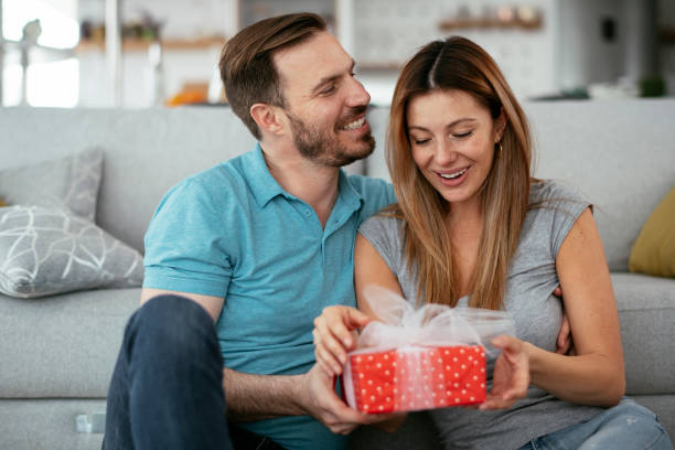 istock Husband surprising his wife with a gift 1277988498