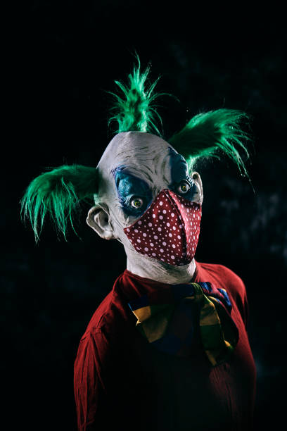 istock disturbing evil clown wearing a red face mask 1277989563