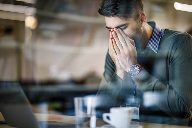 istock Young businessman having a headache while working in the office. 1277991655