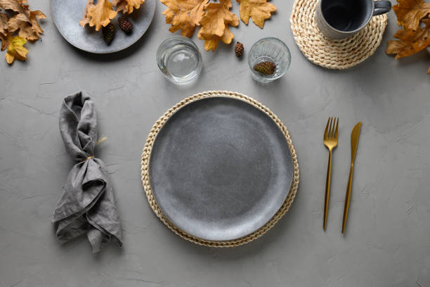 istock Autumn festive table setting with golden decor on grey table. View from above. 1277993888