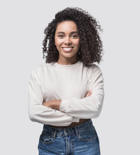 Happy young woman studio portrait Beautiful student girl with crossed arms looking at camera. Studio shot. Isolated on gray background clipping path photos stock pictures, royalty-free photos & images