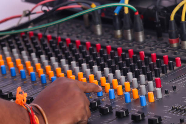 istock Selective Focus On Musical Sound Mixer Equalizer Console And Hands Of Man Adjusting Or Operating The Knobs Of Board 1277996394