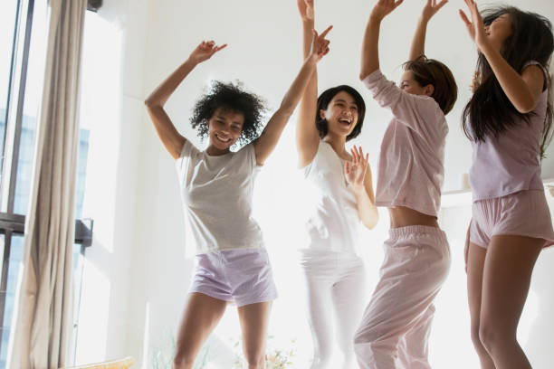 young mixed race girl dancing on bed. - wedding african descent american culture bride imagens e fotografias de stock