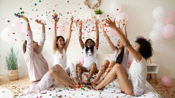 festive young diverse female best friends throwing confetti in air. - wedding african descent american culture bride imagens e fotografias de stock