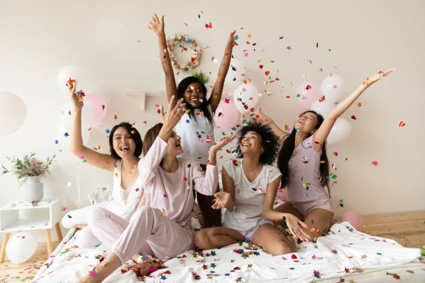istock Happy young festive mixed race diverse women playing with glitter. 1277996513