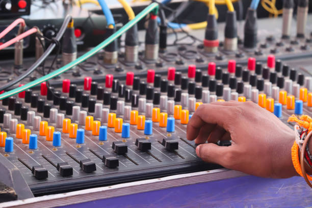 Electronics Musical Sound Mixer Equalizer Console And Hands Of Man Adjusting Or Operating The Knobs Of Board