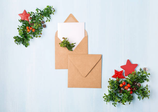 istock Rustic wooden blue background with Christmas empty white card and craft envelopes. 1277997747