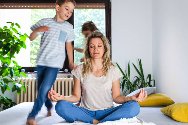 istock While noisy kids running young mother meditates 1277998586