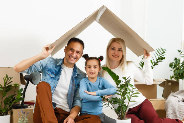 istock Family unpacking cardboard boxes at new home 1277998889