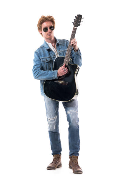 istock Cool confident handsome guitar player playing acoustic guitar in stylish clothes. 1277999549