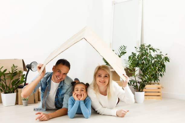 istock Family unpacking cardboard boxes at new home 1277999870