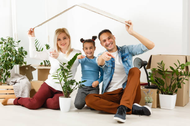 istock Family unpacking cardboard boxes at new home 1278000886