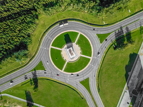Aerial view of the ring road with a three-way fork on a Sunny summer day. City infrastructure. Beautiful top view of the ring road. Different path direction
