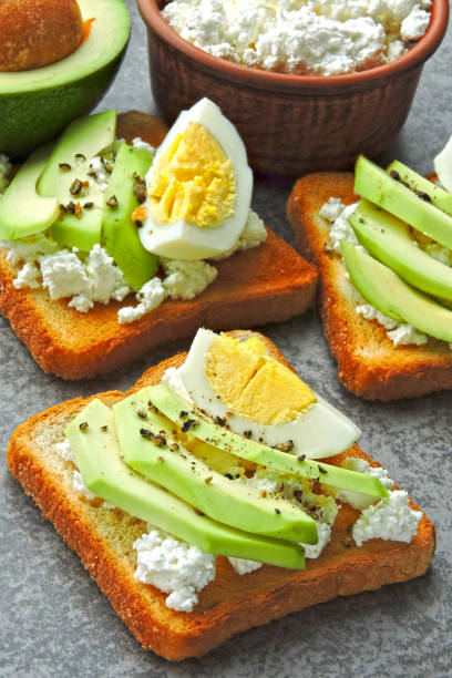 istock Appetizing avocado toasts with cottage cheese and quail eggs. 1278003586