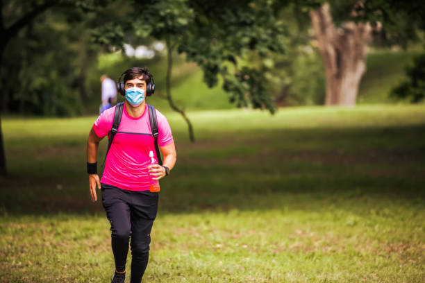 istock Man wearing face mask running alone in the nature 1278004411