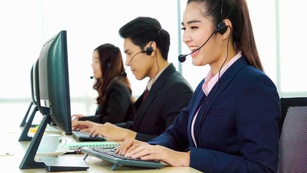 istock Business people wearing headset working in office 1278005338