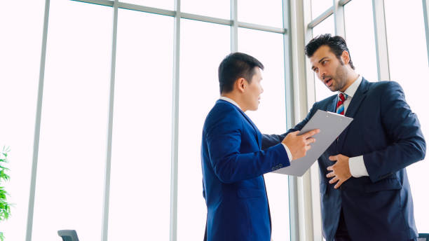 istock Two business people talk project strategy at office 1278006011