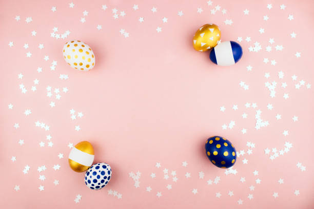 istock Modern trendy golden and blue spring easter eggs flat lay on colorful pink background with stars confetti top view copy space. Happy easter celebration concept. Web banner template. Stock photo. 1278006268