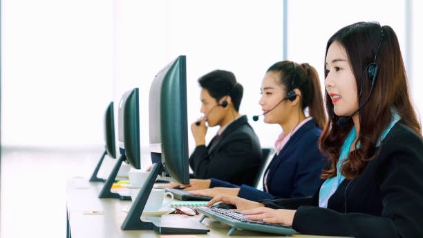 istock Business people wearing headset working in office 1278008386