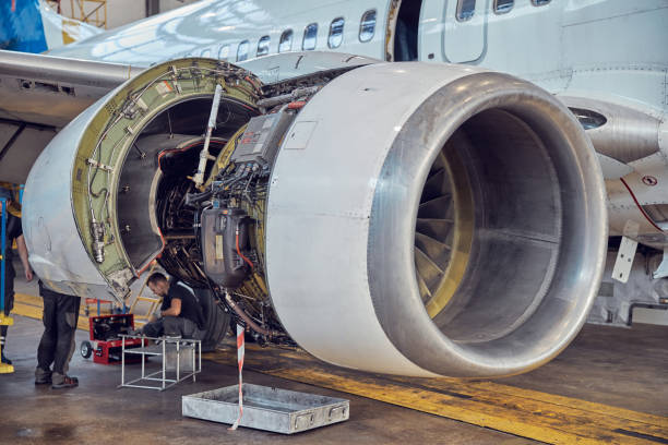 istock Engine aircraft without a hood in the hangar with workers 1278011234