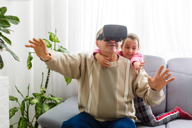 istock Senior man wearing virtual reality goggles at home 1278011710