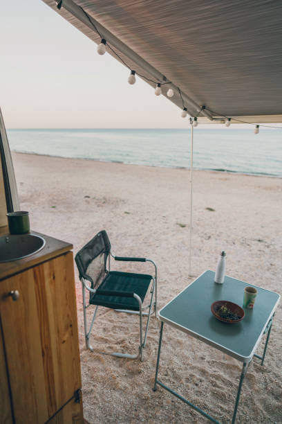 istock Camper van parked near  the sea at sunset 1278011823