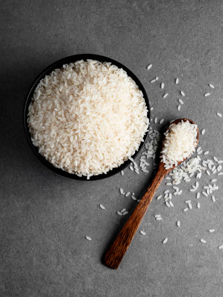 istock Rice grains,  White rice in the bowl, Rice with a spoon, 1278012551