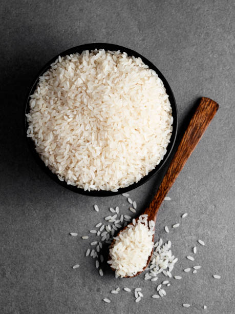istock Rice grains,  White rice in the bowl, Rice with a spoon, 1278012607