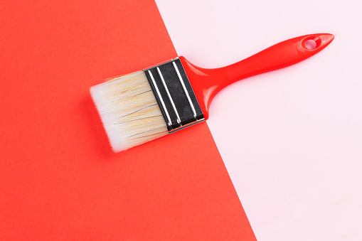 Paintbrush  on pink and red background