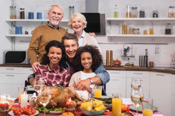 istock Selective focus of multicultural family hugging while celebrating thanksgiving at home 1278015601