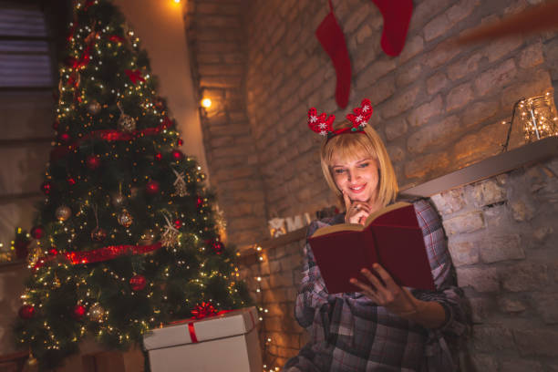 istock Woman reading a book on Christmas Eve 1278017518