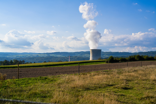 In the foreground a field of farmers in the background the Leibstadt nuclear power plant.