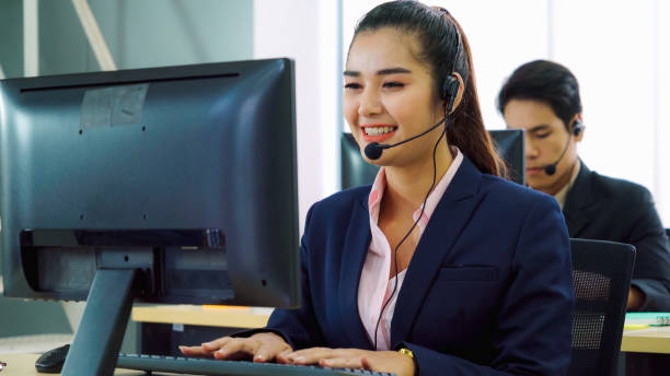 istock Business people wearing headset working in office 1278019938