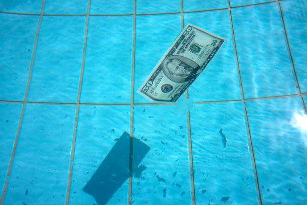 istock Fifty dollar bill swimming on clear blue water 1278021001