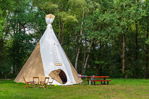 Colorful campsite with teepee or wigwam tents in green area